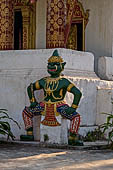 Luang Prabang, Laos. Wat Aham, door guardian statues of the sim. 